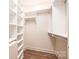 Organized walk-in closet with built-in shelving and wood floors at 0 6Th Nw St, Hickory, NC 28601
