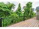 Wooden deck with black metal railings overlooking lush green foliage at 0 6Th Nw St, Hickory, NC 28601