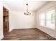 Dining room features wood flooring, modern chandelier, and a bright window with natural light at 0 6Th Nw St, Hickory, NC 28601