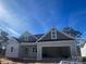 New construction home with a two-car garage and gray siding on a sunny day at 0 6Th Nw St, Hickory, NC 28601