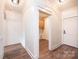 Open hallway with hardwood floors, white trim, and access to laundry room at 0 6Th Nw St, Hickory, NC 28601