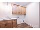 Laundry Room featuring wood floors, light-colored cabinets, a sink and countertops at 0 6Th Nw St, Hickory, NC 28601