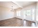 Bright living room with wood floors, modern lighting, and a white front door with side windows at 0 6Th Nw St, Hickory, NC 28601