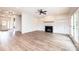 Bright living room with a cozy fireplace, built-in cabinets, wood beam mantle, and doors to outside at 0 6Th Nw St, Hickory, NC 28601