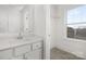 Bathroom featuring a well-lit vanity and a peek into the walk-in closet, offering practicality and style at 10053 Jack Nicklaus Dr # 932, Lancaster, SC 29720