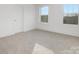 Bright bedroom features neutral carpet, white walls, and two windows at 10053 Jack Nicklaus Dr # 932, Lancaster, SC 29720