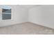 Bright bedroom features neutral carpet, white walls, and one window at 10053 Jack Nicklaus Dr # 932, Lancaster, SC 29720