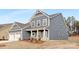 Charming home featuring blue siding, white trim, a well-manicured lawn, and a welcoming front porch at 10053 Jack Nicklaus Dr # 932, Lancaster, SC 29720