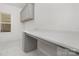 Bright laundry room with gray cabinetry, white counter, and patterned tile flooring at 10053 Jack Nicklaus Dr # 932, Lancaster, SC 29720