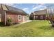 View of the home's backyard with an attached garage with solar panels and a walkway leading to the main building at 104 Bryant St, Belmont, NC 28012