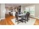 Dining area features a wooden table set on a white rug, next to an open plan kitchen at 104 Bryant St, Belmont, NC 28012