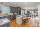 Open kitchen view showcasing the island seating, granite countertops, and stainless steel appliances at 104 Bryant St, Belmont, NC 28012