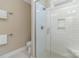 Tiled shower with glass door, rainfall showerhead, and built-in niche at 104 Bryant St, Belmont, NC 28012