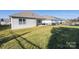 Green backyard with a well-maintained lawn, and a covered patio, offering a serene outdoor living space at 106 Chase Water Dr, Mooresville, NC 28117