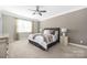 Bright bedroom with neutral decor, ceiling fan, and carpeted floors that provide a peaceful retreat at 106 Chase Water Dr, Mooresville, NC 28117