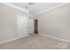 A comfortable bedroom with two doors, neutral paint, and carpet floor at 106 Chase Water Dr, Mooresville, NC 28117