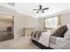Bedroom with ceiling fan, natural light, carpet, and connecting to a dining area, creating a comfortable retreat at 106 Chase Water Dr, Mooresville, NC 28117