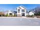 Community clubhouse featuring a clean white facade, ample parking, and easy pool access at 106 Chase Water Dr, Mooresville, NC 28117