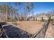 Fully-fenced community dog park featuring mature trees, a water station, and ample space for play at 106 Chase Water Dr, Mooresville, NC 28117