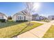 Charming one-story home with landscaped front yard, long driveway and attached two car garage at 106 Chase Water Dr, Mooresville, NC 28117