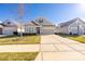 Charming one-story home with landscaped front yard, long driveway and attached two car garage at 106 Chase Water Dr, Mooresville, NC 28117