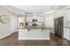 Open kitchen with stainless steel appliances, large center island, and hardwood floors at 106 Chase Water Dr, Mooresville, NC 28117