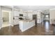 Open kitchen with stainless steel appliances, large center island, and hardwood floors at 106 Chase Water Dr, Mooresville, NC 28117