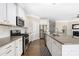 Modern kitchen with stainless steel appliances, granite countertops, and white cabinets at 106 Chase Water Dr, Mooresville, NC 28117