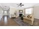 Inviting living room with fireplace, neutral tones, ceiling fan, and hardwood flooring for comfortable living at 106 Chase Water Dr, Mooresville, NC 28117