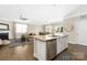Open-concept living area with fireplace flows into kitchen and dining, creating a warm and inviting space at 106 Chase Water Dr, Mooresville, NC 28117