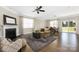 Cozy living room featuring a fireplace, ceiling fan, and adjacent dining area with sliding door access at 106 Chase Water Dr, Mooresville, NC 28117