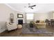 Bright living room with fireplace and natural light, flowing into the dining area, creating a comfortable atmosphere at 106 Chase Water Dr, Mooresville, NC 28117