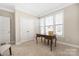 Bright office space filled with natural light from large windows, featuring a classic wooden desk and ample storage at 106 Chase Water Dr, Mooresville, NC 28117