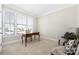 A serene office space filled with natural light, a wooden desk, and chairs at 106 Chase Water Dr, Mooresville, NC 28117