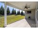 Covered patio overlooking a well-manicured lawn, perfect for outdoor relaxation and entertaining in a peaceful setting at 106 Chase Water Dr, Mooresville, NC 28117