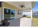 Covered patio with ceiling fan and sliding glass door, creating a seamless transition to outdoor living and backyard enjoyment at 106 Chase Water Dr, Mooresville, NC 28117