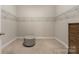 A functional walk-in closet with ample storage space and a sitting stool at 106 Chase Water Dr, Mooresville, NC 28117