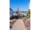 Brick walkway between homes leads to a serene lake view and gazebo for relaxing strolls at 106 Chase Water Dr, Mooresville, NC 28117