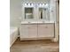 Bathroom with dual sink vanity, framed mirrors, and modern lighting at 11339 Fox Hill Dr, Charlotte, NC 28269