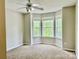 Bright bedroom featuring a ceiling fan and a bay window offering ample natural light at 11339 Fox Hill Dr, Charlotte, NC 28269