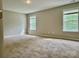 Spacious bedroom featuring carpet and two large windows at 11339 Fox Hill Dr, Charlotte, NC 28269