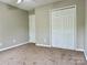 Bedroom with neutral carpet, a closet, and a door leading to another room at 11339 Fox Hill Dr, Charlotte, NC 28269