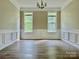 Dining room with wood-look floors, neutral paint, elegant trim, and a contemporary light fixture at 11339 Fox Hill Dr, Charlotte, NC 28269