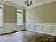 Dining room with wood-look floors, neutral paint, elegant trim, and a contemporary light fixture at 11339 Fox Hill Dr, Charlotte, NC 28269