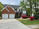 Charming two-story home with a brick facade, lush landscaping, and a two-car garage at 11339 Fox Hill Dr, Charlotte, NC 28269