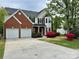 Charming two-story home with a brick facade, lush landscaping, and a two-car garage at 11339 Fox Hill Dr, Charlotte, NC 28269
