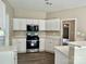 Kitchen featuring white cabinets, and stainless steel oven and microwave at 11339 Fox Hill Dr, Charlotte, NC 28269