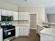 Modern kitchen with stainless steel oven and microwave and white cabinets at 11339 Fox Hill Dr, Charlotte, NC 28269