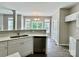 Eat-in kitchen features stainless steel dishwasher and white cabinets at 11339 Fox Hill Dr, Charlotte, NC 28269