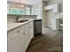Eat-in kitchen features stainless steel dishwasher and white cabinets at 11339 Fox Hill Dr, Charlotte, NC 28269